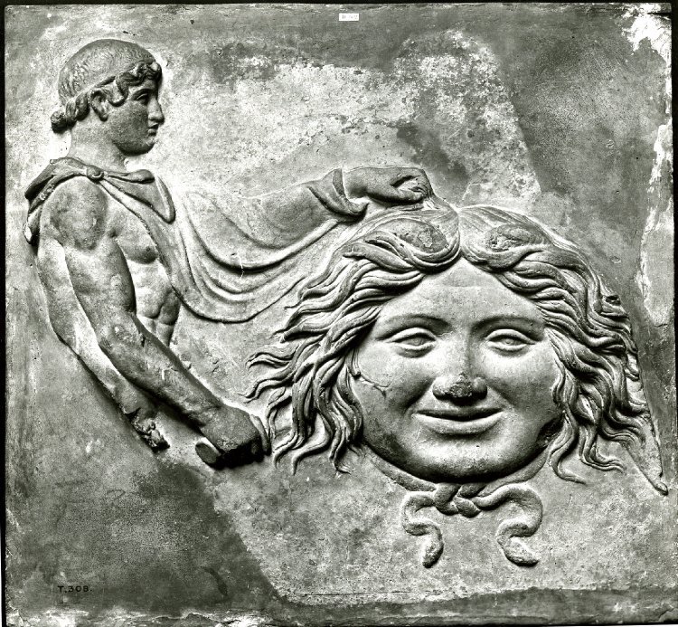 Fragment of a terracotta Campana relief: head of gorgon with of Perseus wearing a fillet and chlamys on the left. Roman 50BC- 100 AD Source: British Museum