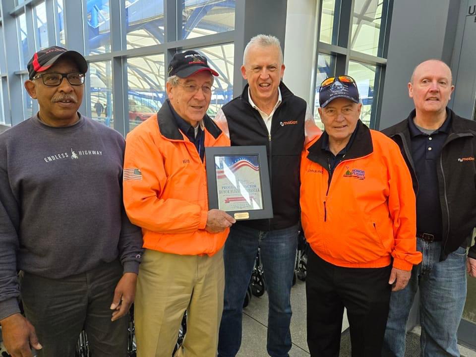 HonorFlightROC's tweet photo. Doug Westerdahl of Numotion (Monroe Wheelchair) receives Proud Benefactor Plaque from President Rich Stewart for their generous support which began with Doug being the Guardian for his father Bruce on M57 in October 2017. Thank you Numotion! #honorflightrochester https://t.co/2phcN5Vb5w
