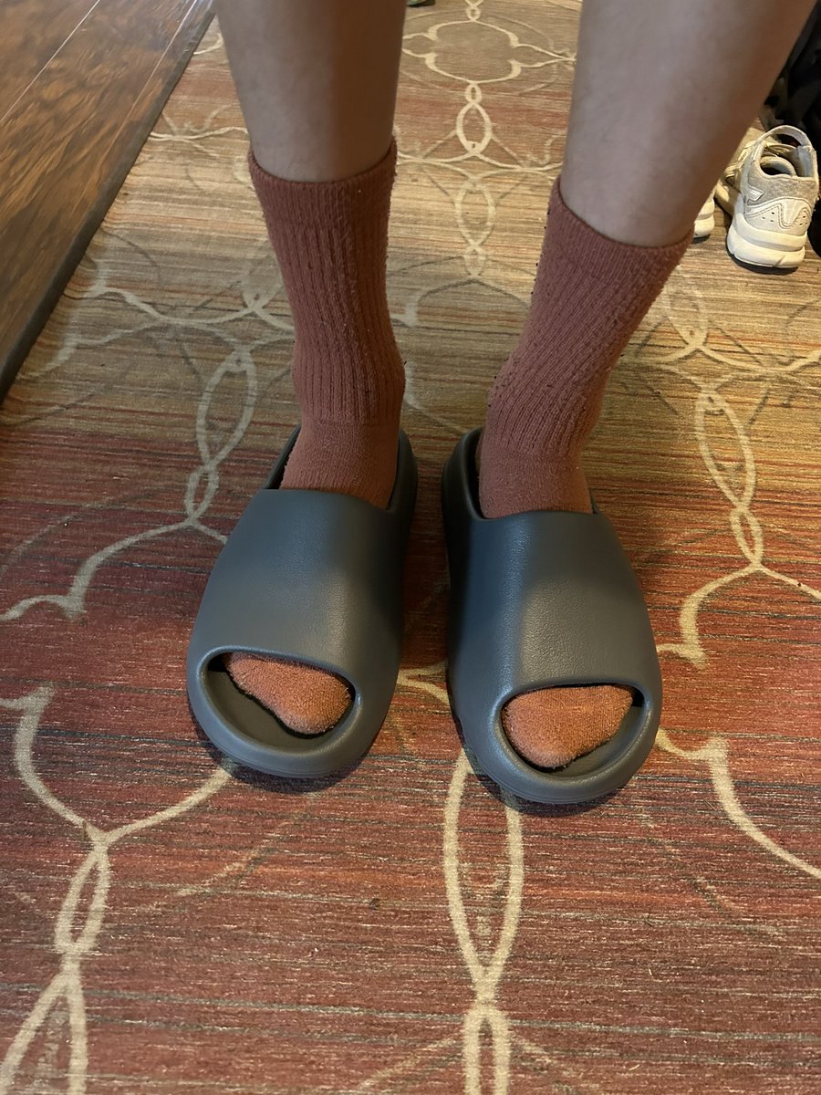 brown yeezy slides on feet