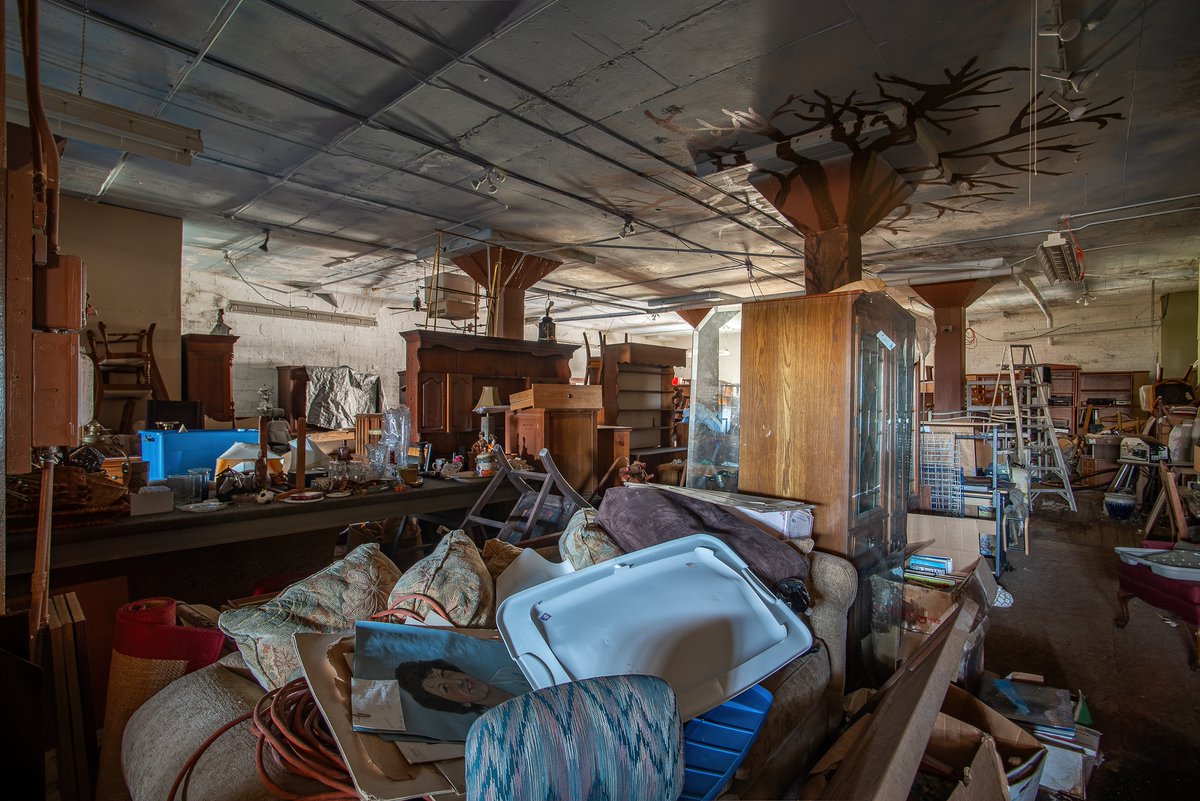 An abandoned consignment shop in Michigan. All of this stuff, once belonging to other people, now collecting dust and mildew in the quiet darkness.