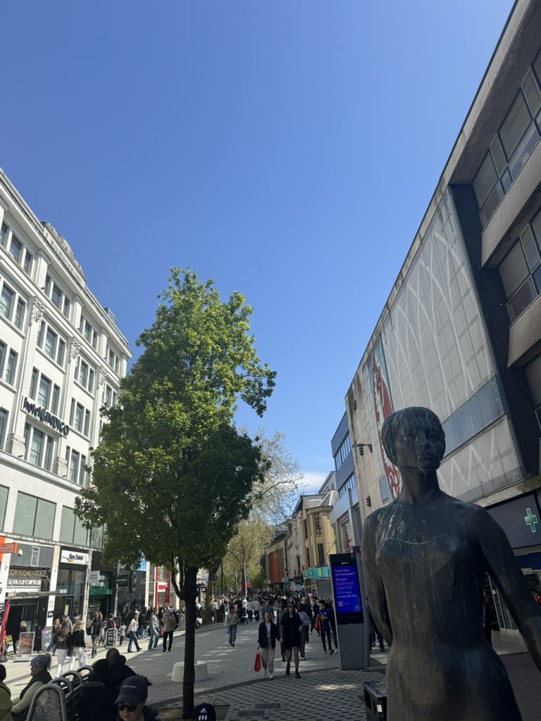 On this lovely morning in Cardiff, the sun is shining bright and the birds are singing their sweet melodies, creating a perfect atmosphere for a peaceful walk in the city.