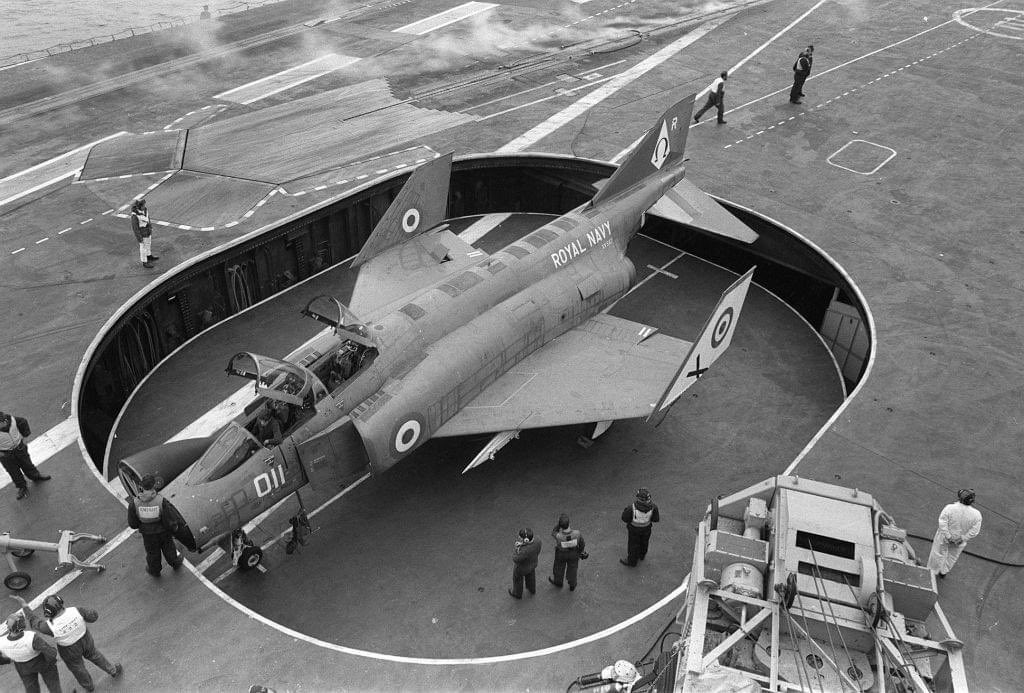 Tight fit. F4 of 892 NAS GOING down forward lift HMS Ark Royal. Phantom servicing was carried out on the upper hangar deck, and Buccaneers on the lower. Hot places in tropical climes.