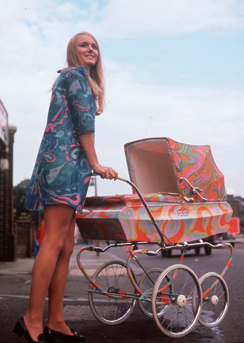 A woman pushing her baby in a groovy psychedelic pram, London, in 1967. #swingingsixties #1960s #parenting #london