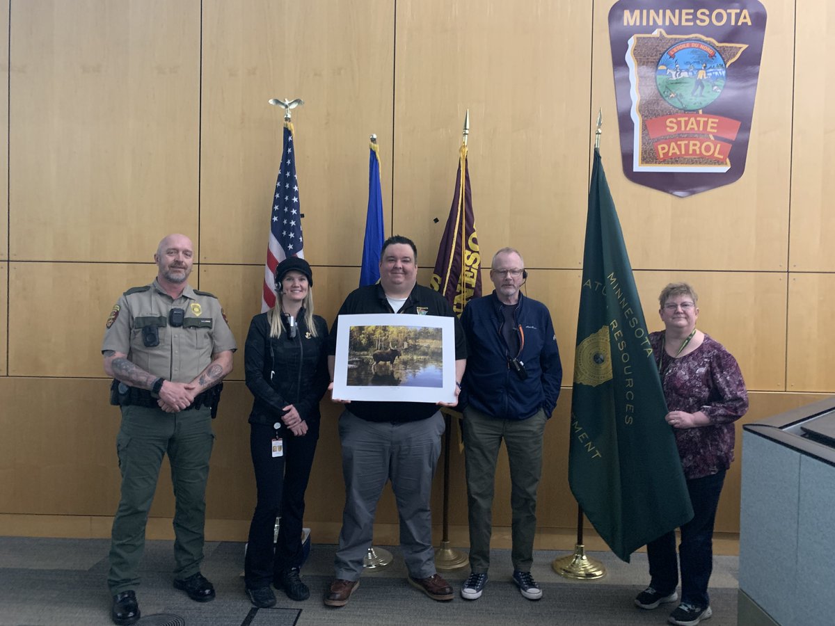 To honor the work dispatchers do and in recognition of National Public Safety Telecommunicators Week, Aaron Kahre (far left) and Patty Holt (right right) from DNR Enforcement presented State Patrol Dispatch staff with a print from Turn in Poachers. We salute their service!