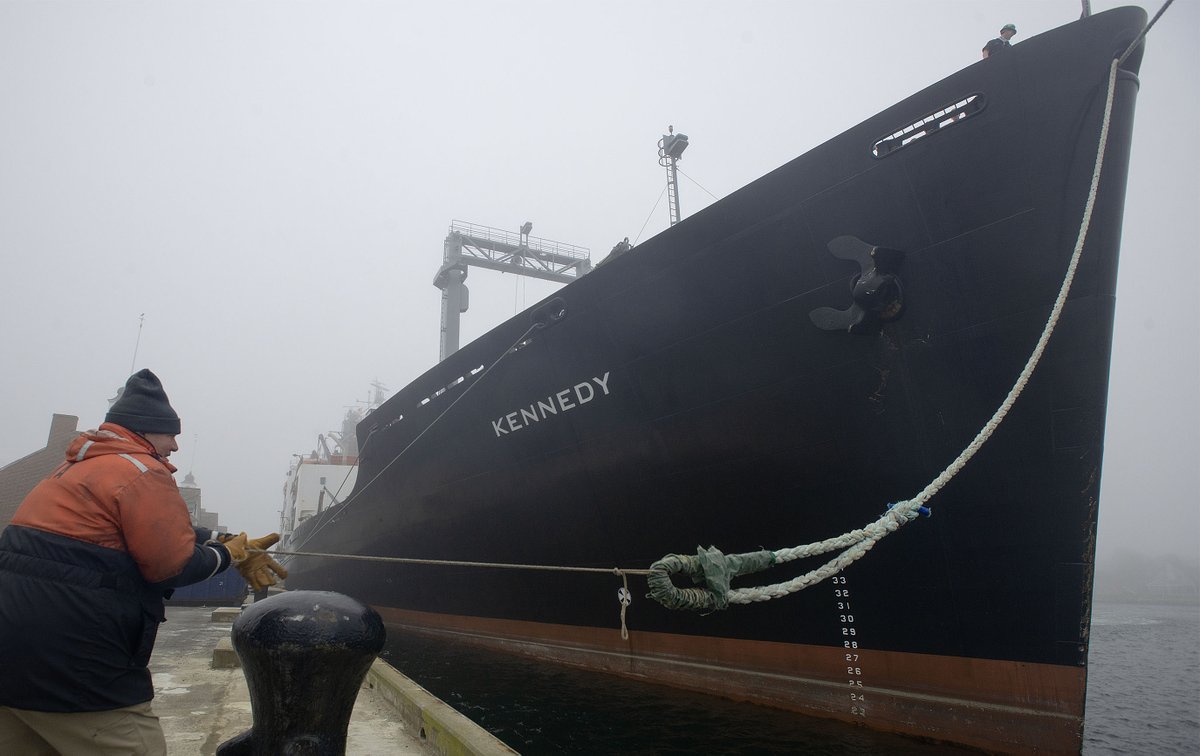 MMA's Bill Klimm hauls a bow line back to shore from the TS Kennedy as a thick fog bank swept across the Cape Cod Canal just minutes before the ship was slated to leave on their annual training cruise forcing a delayed departure to later Saturday afternoon. @capecodtimes