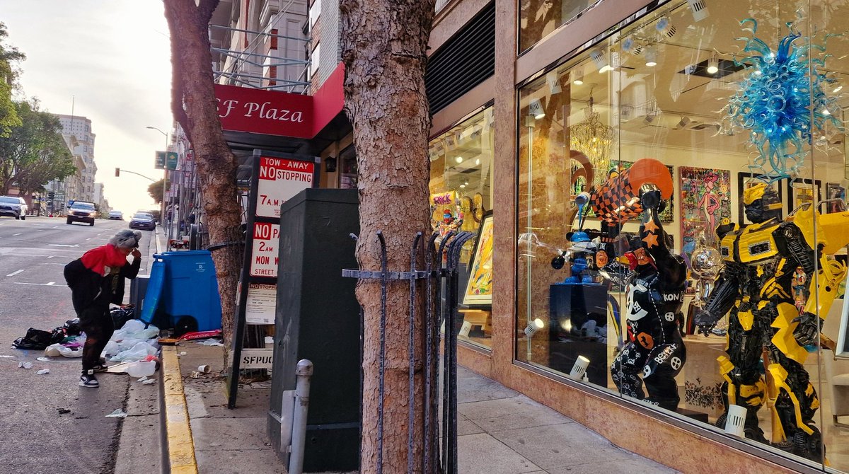 San Francisco encapsulated in one photo: On the right, a garish shop full of brightly coloured bling. On the left, a gibbering crack head burrowing through the bins.