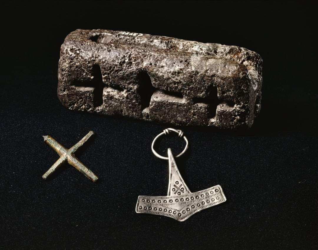 This casting mold from Trendgården, Denmark, dates back to 10th Century AD. It’s made of soapstone and was used for casting both pagan Mjöllnir amulets and Christian crosses. This suggests a syncretistic tendency on behalf of the Norse, allowing an amalgamation of religions.

The