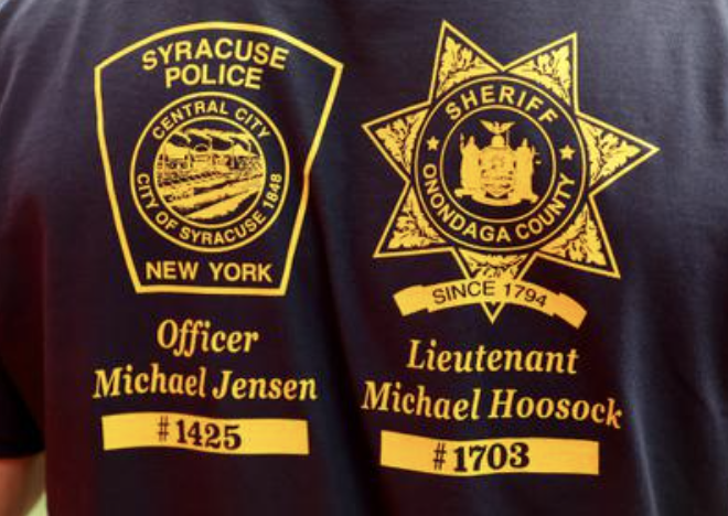 .@CuseMLAX are wearing t-shirts during pregame warmups to honor Syracuse Police officer Michael Jensen and Onondaga County Sheriff Lt. Michael Hoosock who were killed in the line of duty earlier this week.