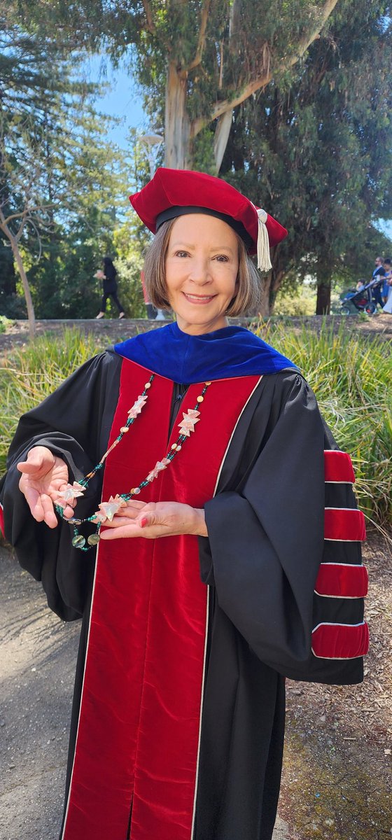 Prez @CathySandeen is wearing a ceremonial neck piece gifted to @CalStateEastBay from the Muwekma Ohlone Tribe to be worn at special events such as our Honors Convocation today. It features red abalone. @calstate @DiversityCSUEB