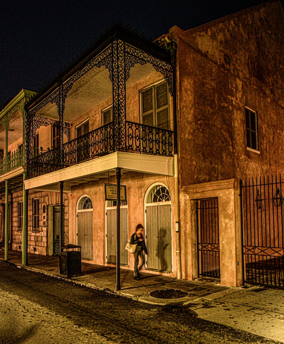 Woman and shadow checking their phones, Royal street, New Orleans