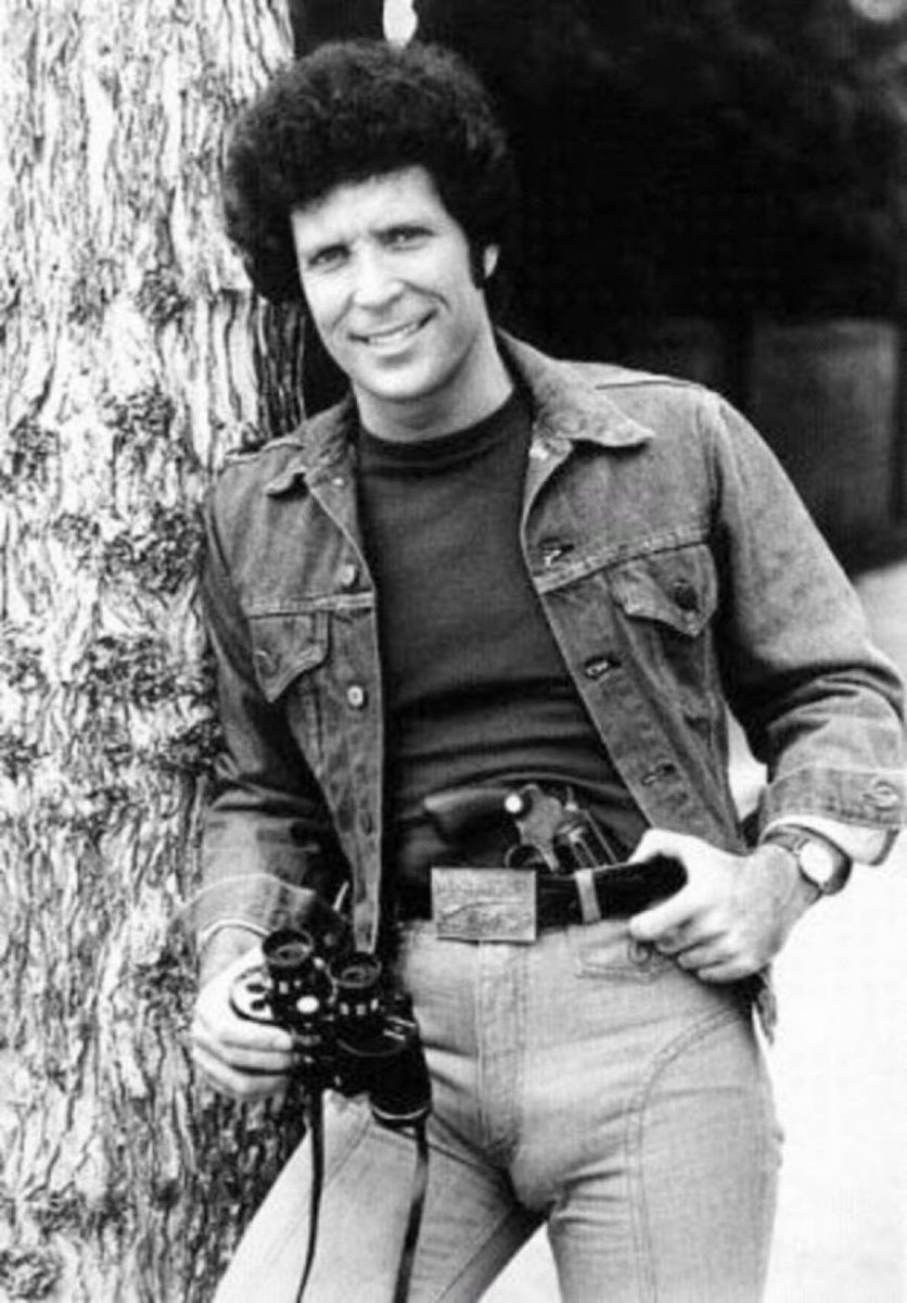 Super70sSports's tweet image. May Tom Jones leaning against a tree with a pair of binoculars and a goddamn hand cannon stuffed down his skin-tight jeans serve as an invitation for you to also live your best life.