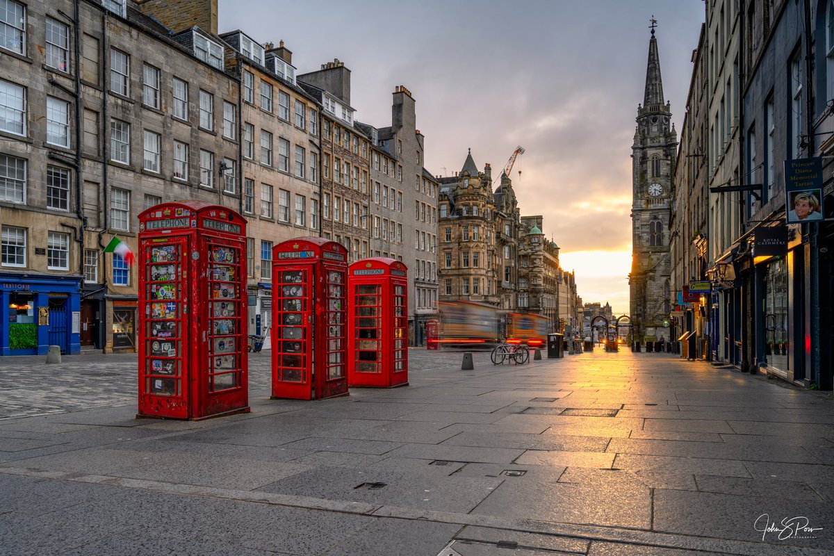 Three red phone boxes on the Royal Mile, Edinburgh.