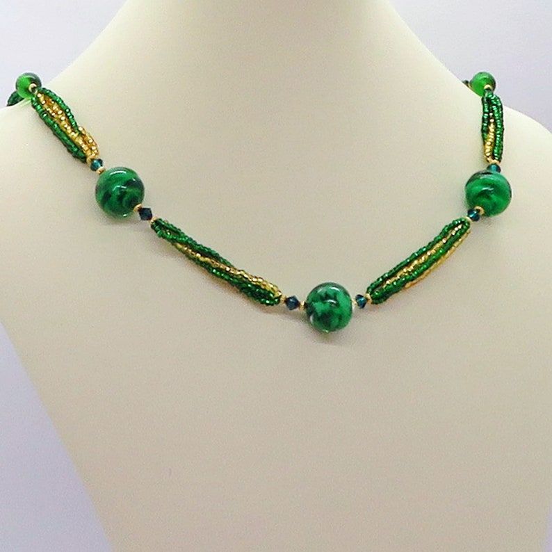 Experience the beauty of Venetian Glass with this Brilliant Hunter Green Beaded Statement Necklace from RivendellRocksSedona. Perfect for adding a pop of color to any outfit! #VenetianGlass #StatementNecklace buff.ly/3Rn0S2P