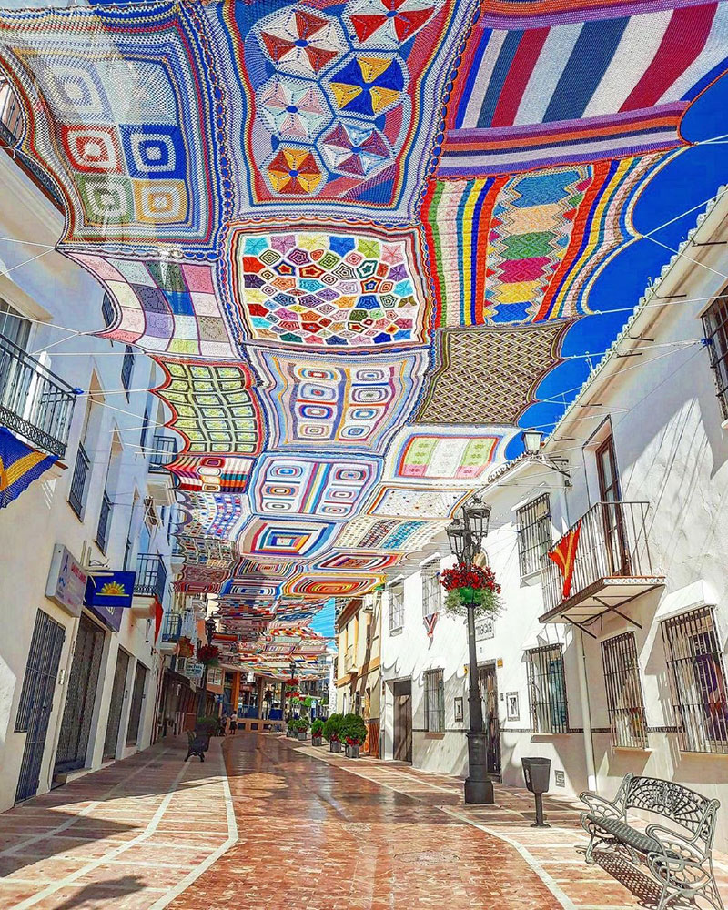 Eva Pacheo, a local crochet teacher and her students in Alhaurín de la Torre, in Malaga, Spain, collaboratively created a massive canopy of patchwork crochet to create shade for their community #WomensArt