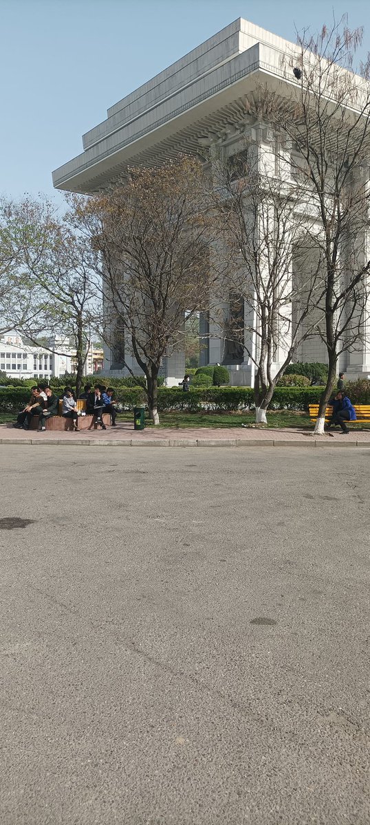 DPRK citizens relax near to the Arch of Triumph