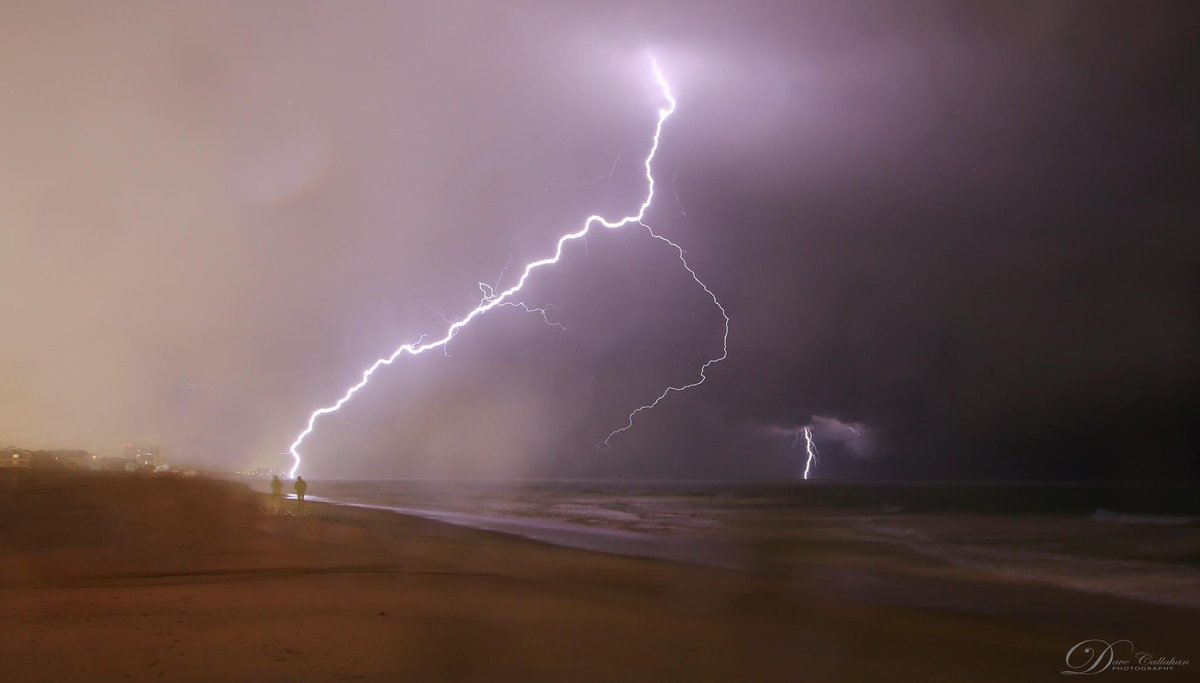 Lightning strikes the water near Surfside Beach. Look carefully and you see two people walking on the beach. Imagine what their reaction was when that bolt hit! 📸 Dave Callahan. #scwx #ncwx