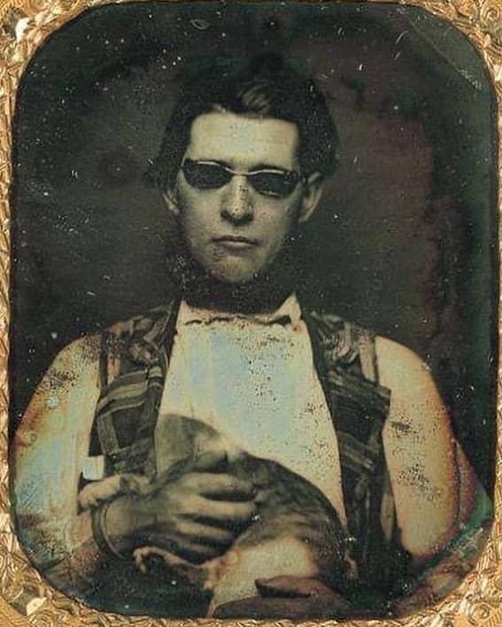 Daguerreotype of a man, believed to be blind, wearing tinted glasses and holding a cat, c. 1850.  >rarehistoricalphotos.