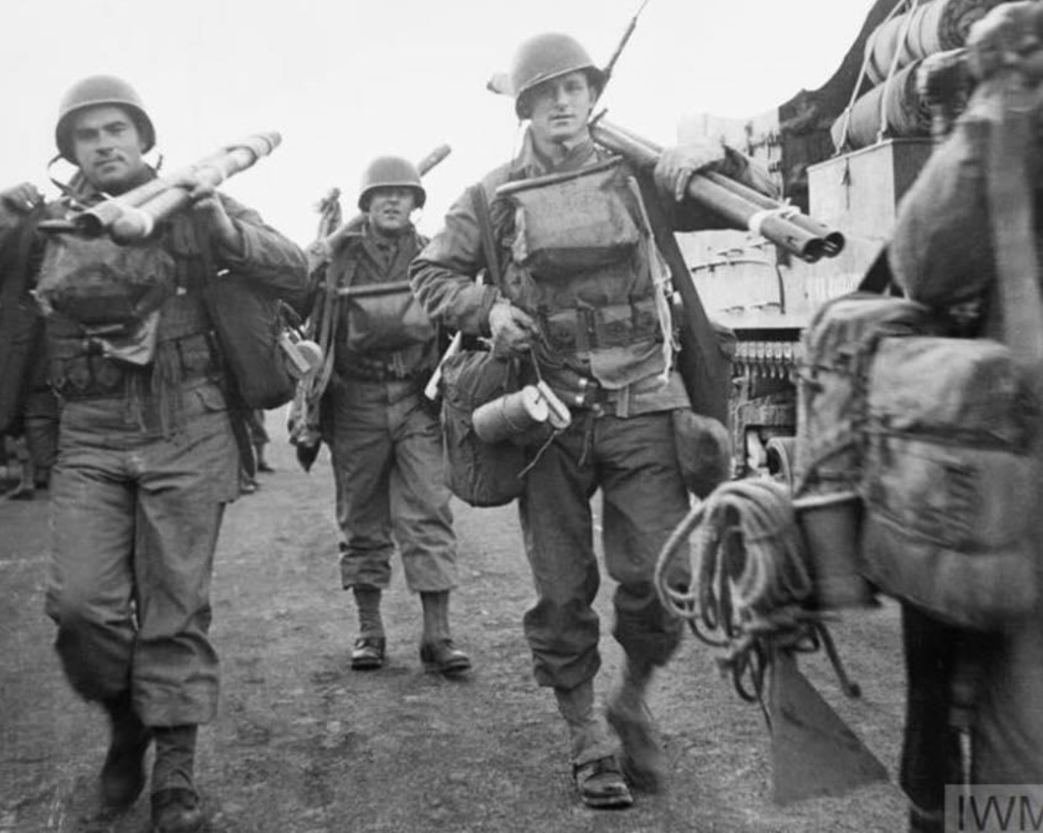 In June of 1944, American troops loaded down with their weapons, personal kits & Bangalore torpedoes make their way to the embarkation point on the south coast of England in preparation for the invasion of Europe. 🪖