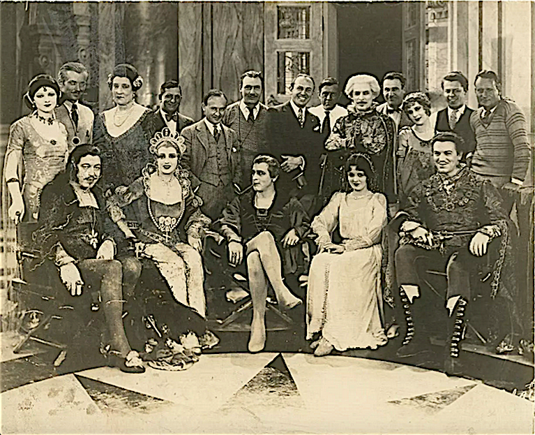 Cast and crew of Warner Bros./Vitaphone's 'Don Juan' (1926). John Barrymore smokes a pipe, flanked by Warner Oland, Estelle Taylor, Mary Astor, and Montagu Love. Back row contains Myrna Loy, director Alan Crosland, Jack Warner, and others.