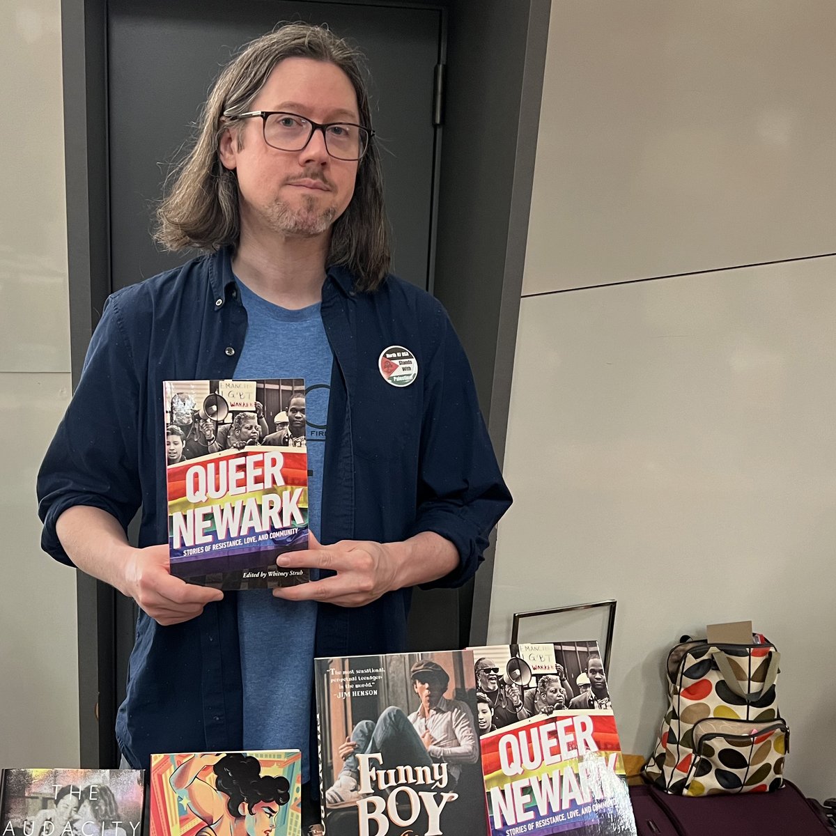 Whitney Strub, editor of 'Queer Newark: Stories of Resistance, Love, and Community,' at our exhibit table at the Rainbow Book Fair. rutgersuniversitypress.org/queer-newark/9… #RainbowBookFair @RainbowBookFair #LGBTQ