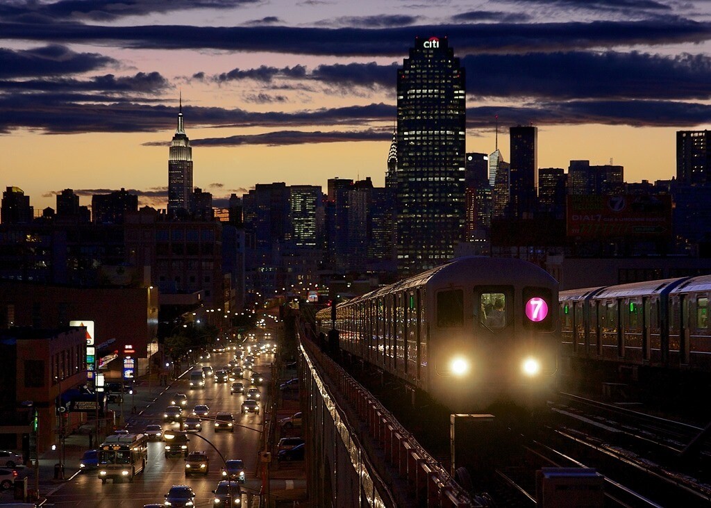 #TodayinHistory: #OnThisDay in 1917, the IRT Flushing Line opened between Queensboro Plaza and 103rd Street – Corona Plaza. Today, it has been dubbed the “subway line with the best views.”

Can you identify which station this photo by Dennis Livesey was taken from?