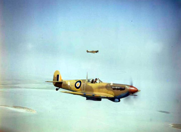 Two clipped-wing Supermarine Spitfire VBs of No. 40 Squadron, South African Air Force, which served in a ground support role in North Africa. Here, ER622/`WR-D' accompanied by another Spitfire of the Squadron patrols over the Tunisian coast in the spring of 1943.