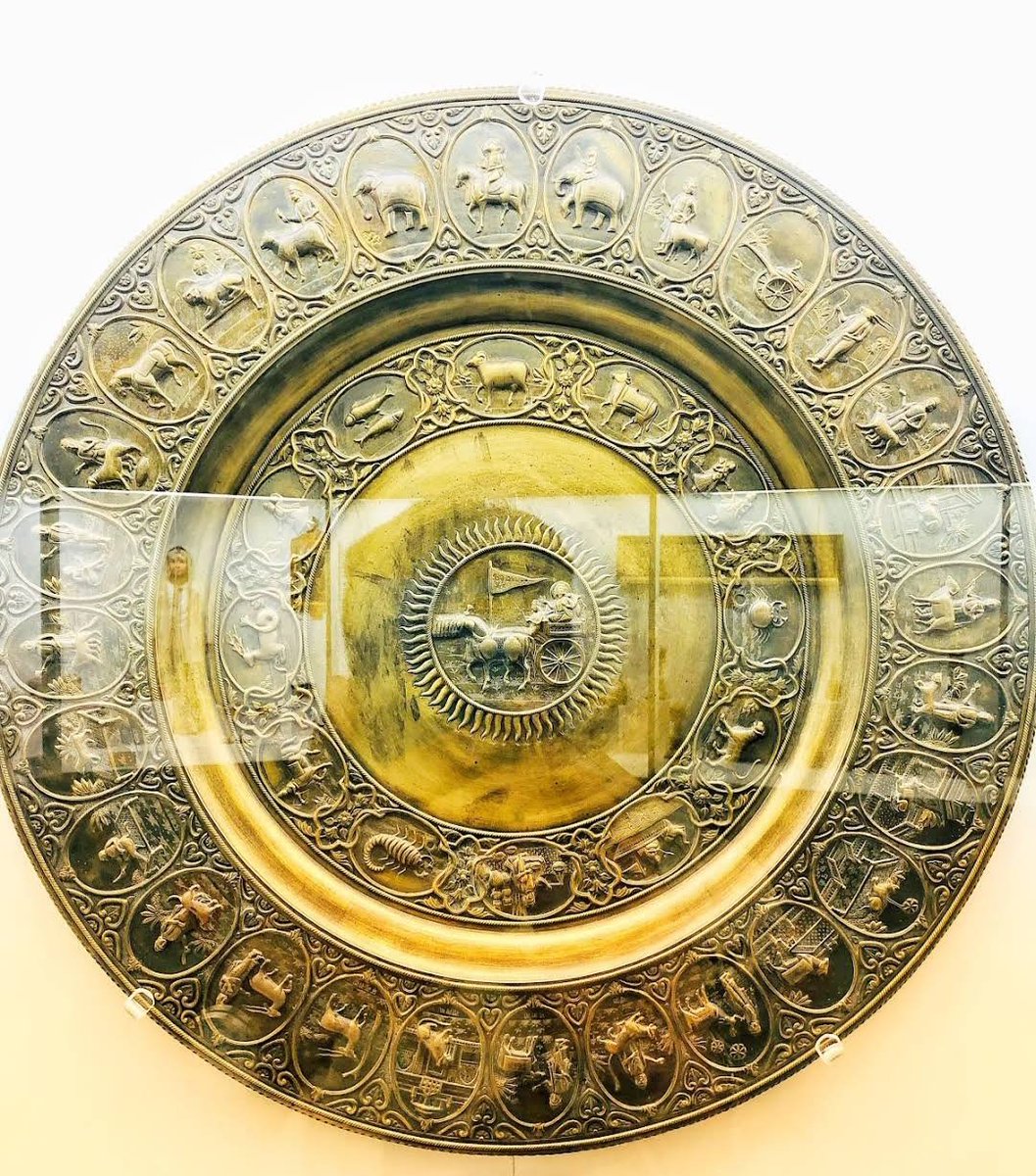 A beautiful plate from Bikaner, in the centre of which is shown Sun god surrounded by zodiac signs. Probably used for purpose of Puja.