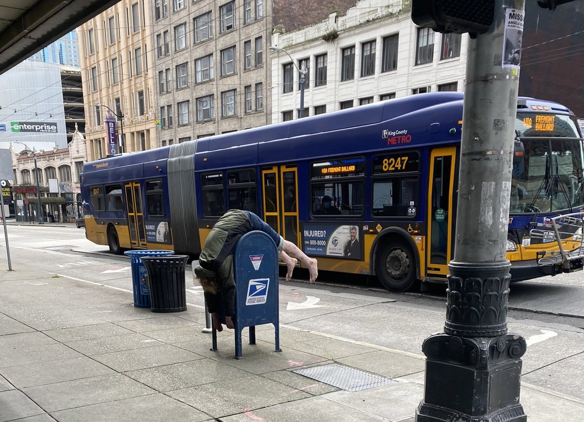 .@kevinvdahlgren photographed a person sleeping on a public mailbox in Seattle: