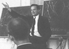 Richard Feynman delivering a lecture at the Jablonna conference on gravitational physics in August 1963. The conference was held near Warsaw, Poland. Note the 'Feynman diagrams' on the blackboard behind him.