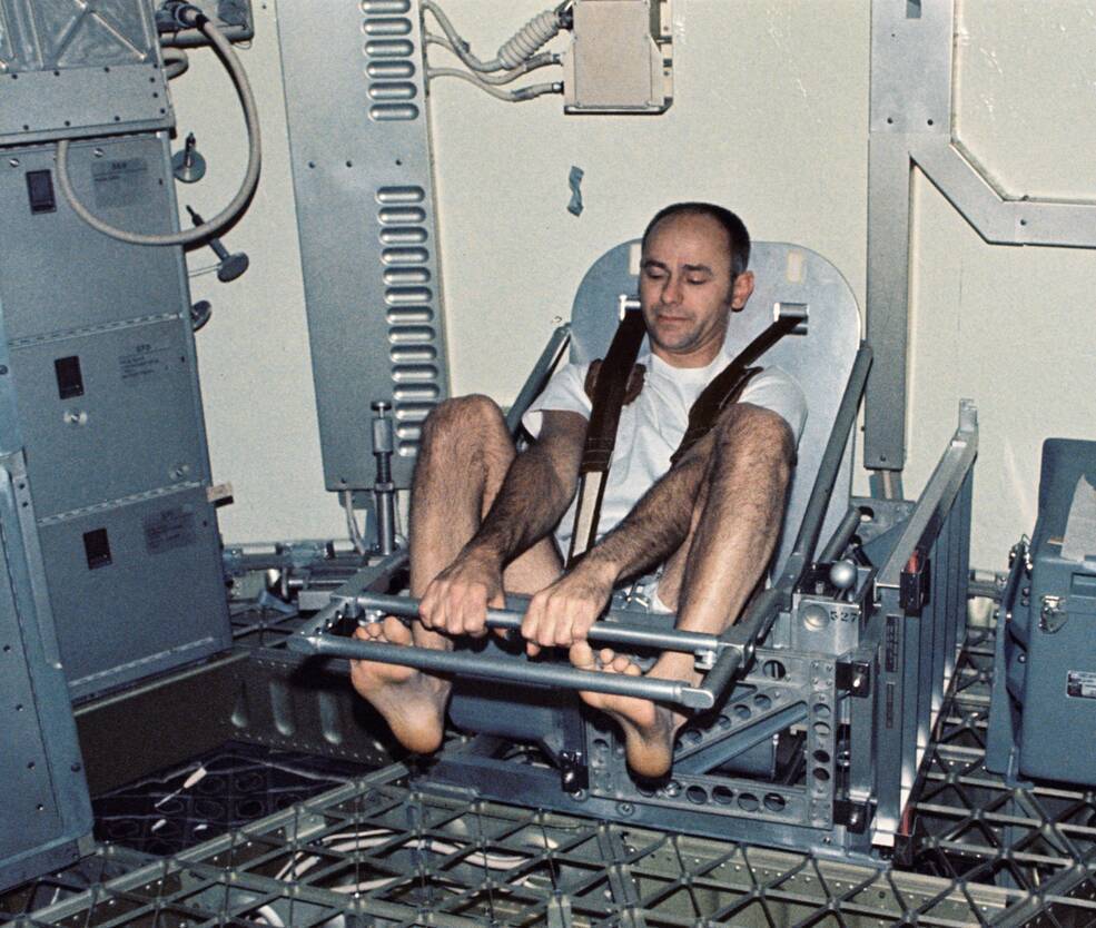 Al Bean measures his weight using the Body Mass Measurement Experimen onboard Skylab. NASA image.
