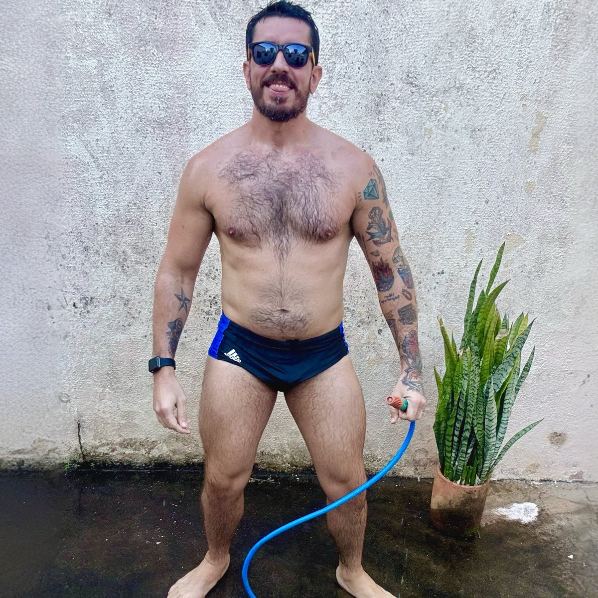 Agora de óculos e com a mangueira na mão.