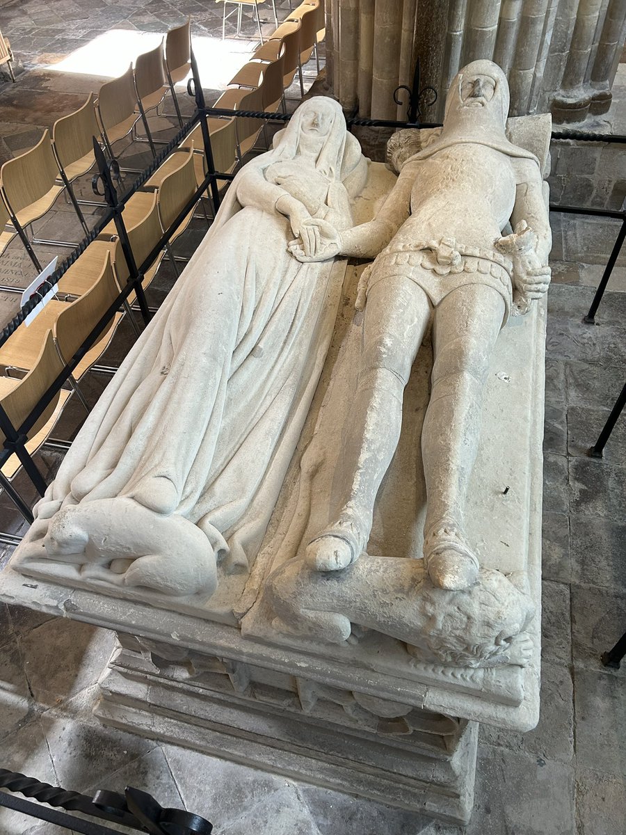 An Arundel Tomb BY PHILIP LARKIN Side by side, their faces blurred,    The earl and countess lie in stone,    Their proper habits vaguely shown    As jointed armour, stiffened pleat,    And that faint hint of the absurd—    The little dogs under their feet…