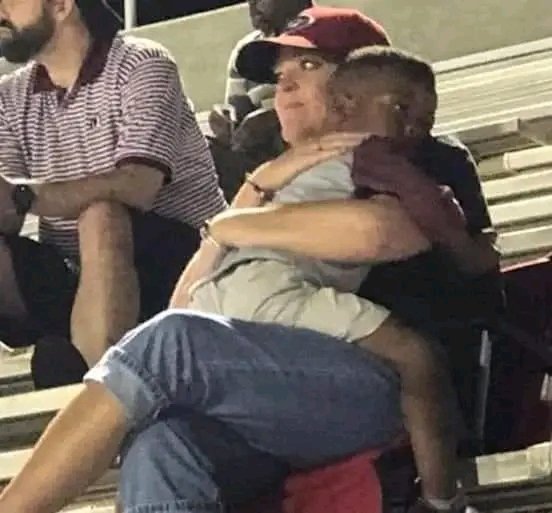 You would think that the woman and boy in this photos are relatives, or at least lifelong friends, but in fact they had never met before until they spotted each other at a football game. The photo was originally shared on Facebook by the boy's auntie, Star, who was touched by the