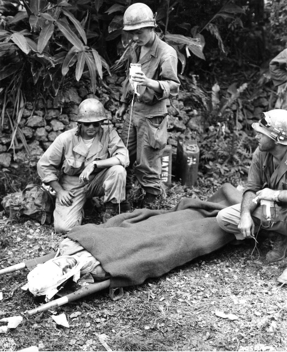In April of 1945, Captain James Barron of the 96th Infantry Division is given plasma after being wounded by a Japanese sniper on Okinawa. 🪖