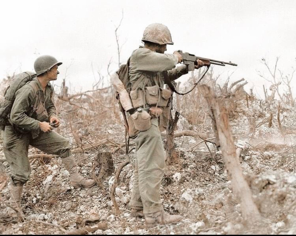 In 1945, a BAR man takes aim as another prepares to pull the pin on a grenade during the Battle of Okinawa. 🪖