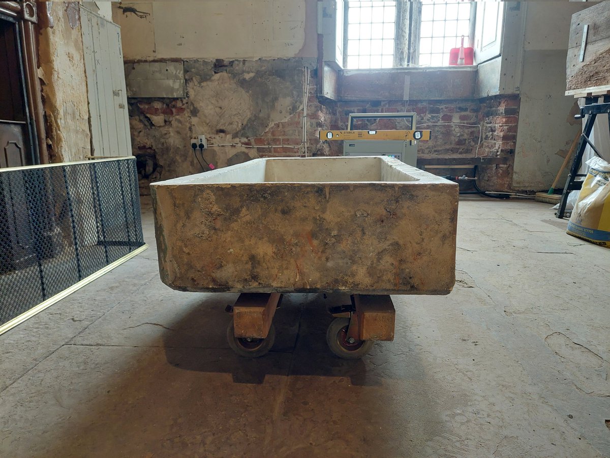 A large and heavy ceramic sink removed from and about to reinstalled in a Butler's pantry. The pantry had changed use to become a technician's workshop and the intention is to restore the room to its former status.