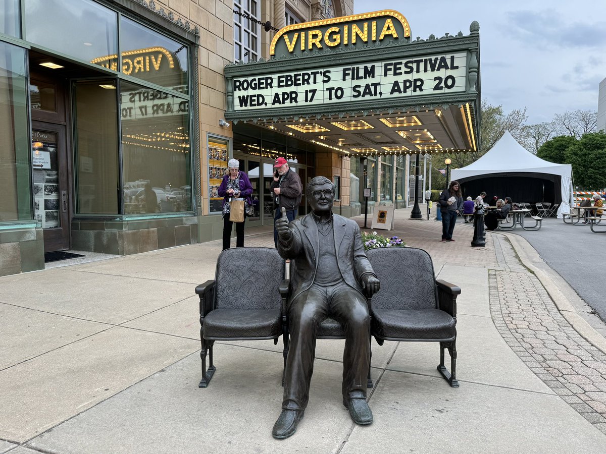 markpfeiffer's tweet photo. Ebert sculpture, the fabled men’s room view of downtown Champaign from the Virginia Theatre, Scott Alexander and Larry Karaszewski with Chaz Ebert after MAN ON THE MOON, and the marquee at night. #Ebertfest https://t.co/Mp6QCXxoze