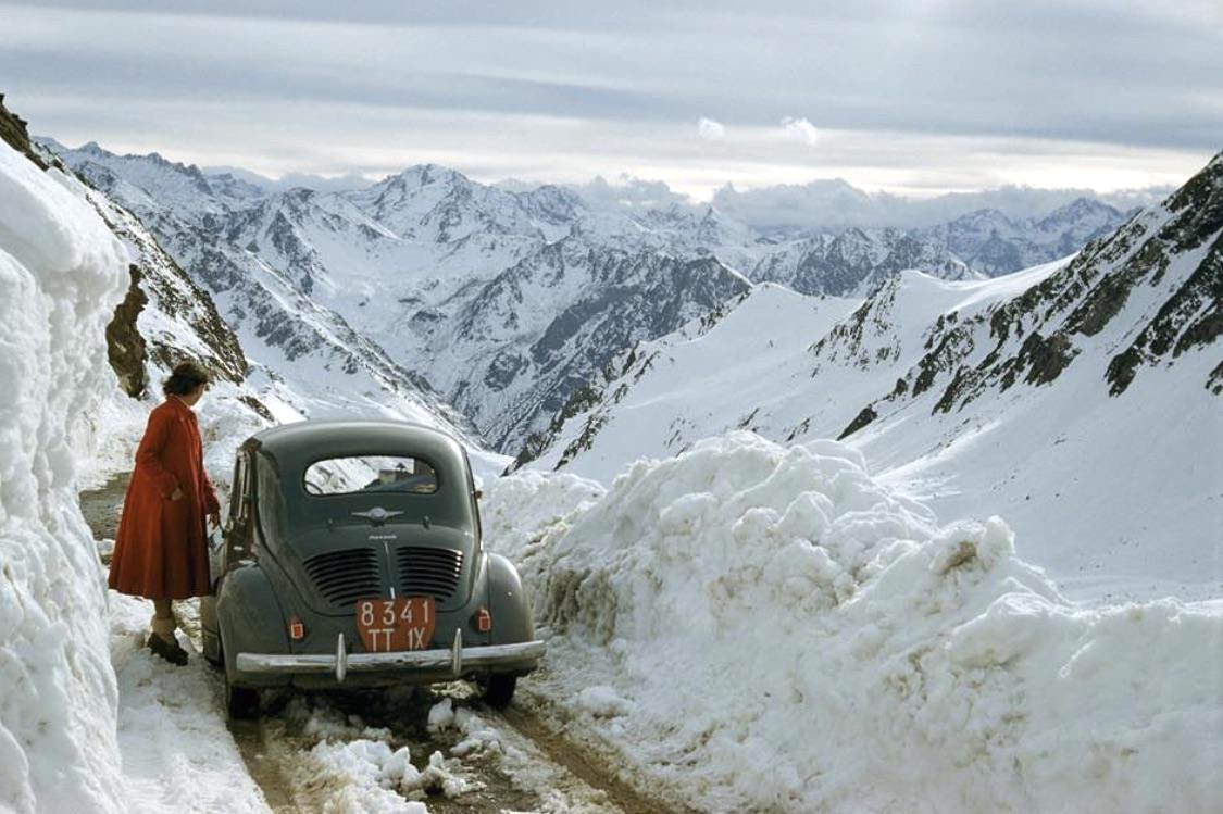 A woman overlooking a snowy mountain pass in The Pyrenees Mountains, France, 1956 - by Justin Locke, American