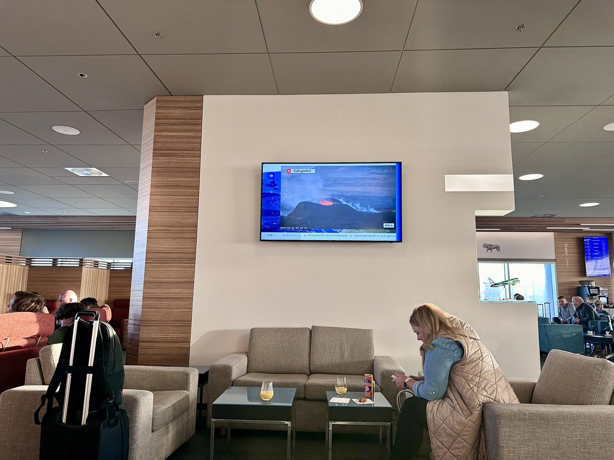 The tv news in the lounge at Reykjavik airport keeps cutting to a livestream of the eruption and it’s hard to see it other than as a metaphor for the global news.