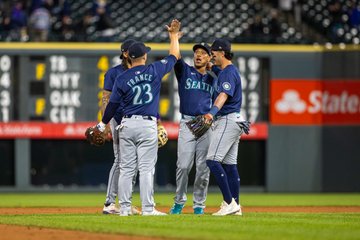 Photo of J.P. Crawford, Jorge Polanco, Josh Rojas and Ty France celebrating on the infield. 