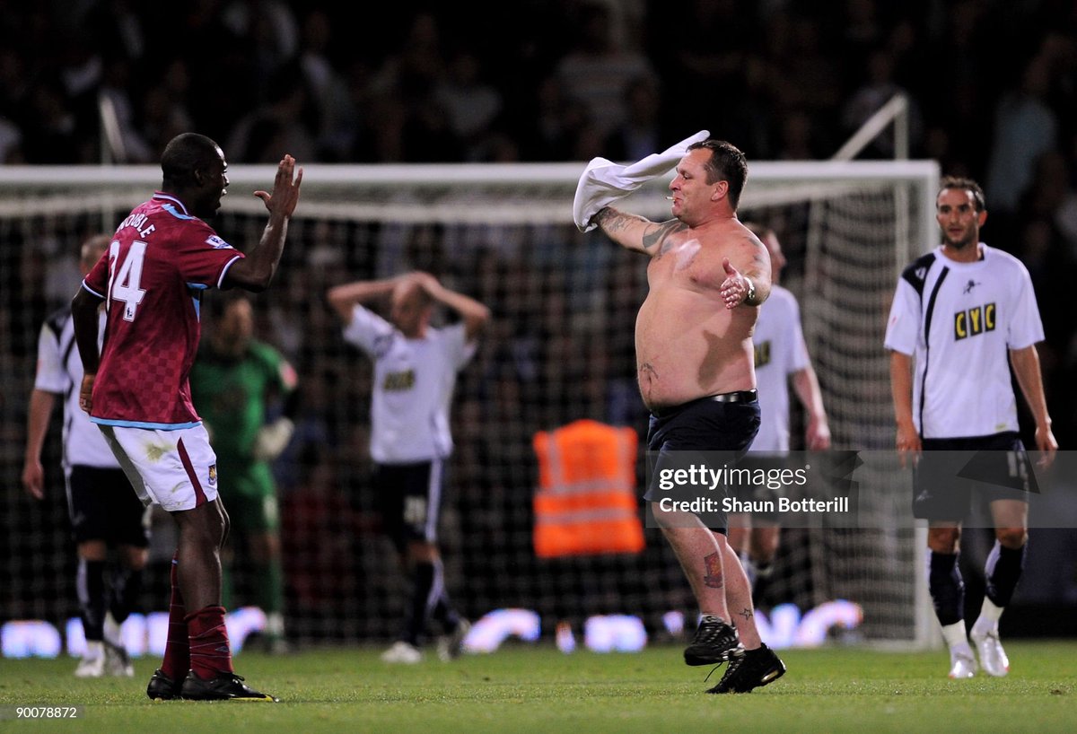 Frank Nouble of West Ham United tries to stop fans coming on the pitch during the Carling Cup second round match between West Ham United and Millwall at Upton Park (2009)