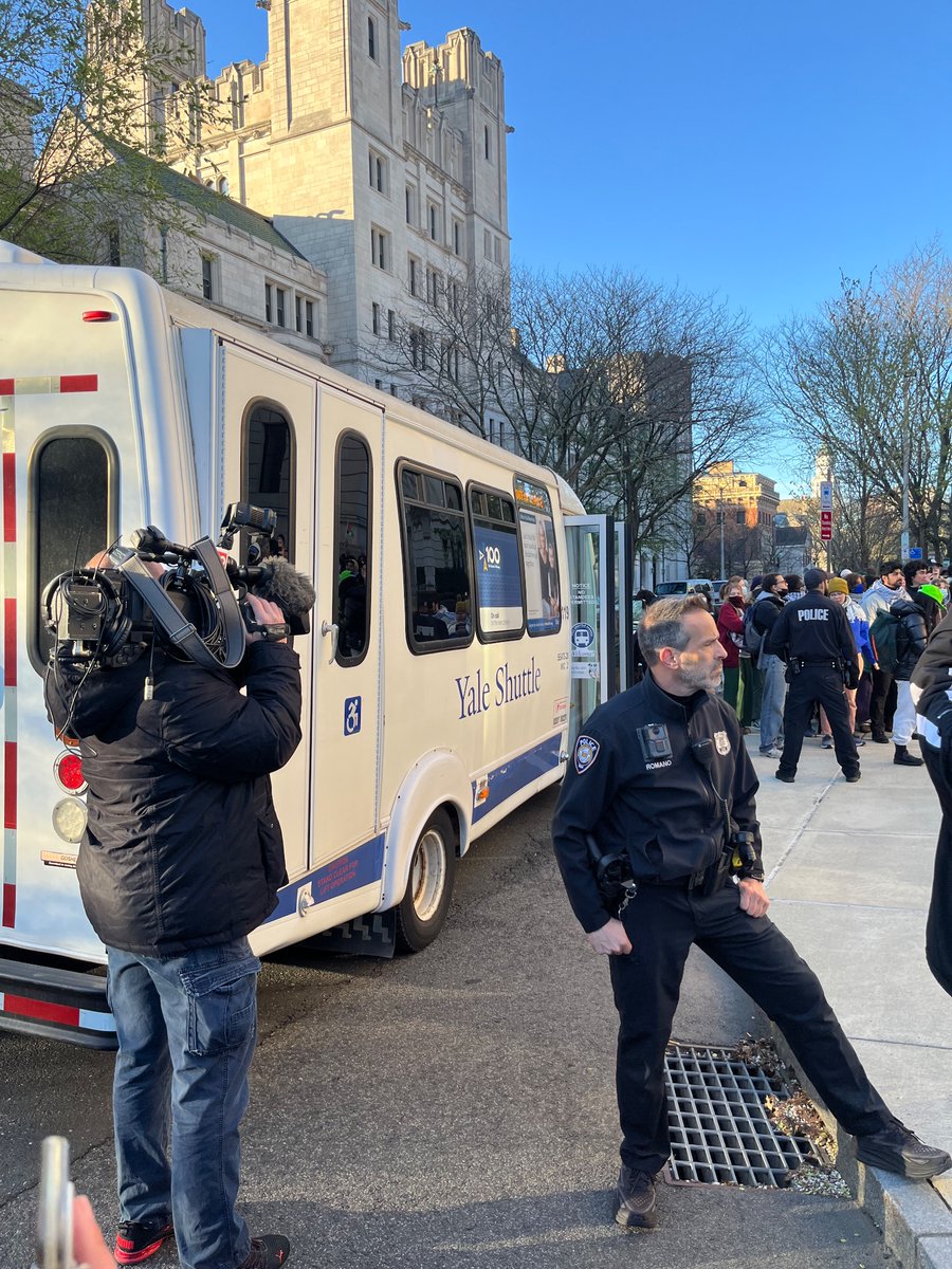 Jaydukelives's tweet image. Yale students are being loaded into Yale buses to be carted off to jail. 36 degrees in New Haven this morning but several hundred peers and professors have gathered to cheer on those willing to be arrested.