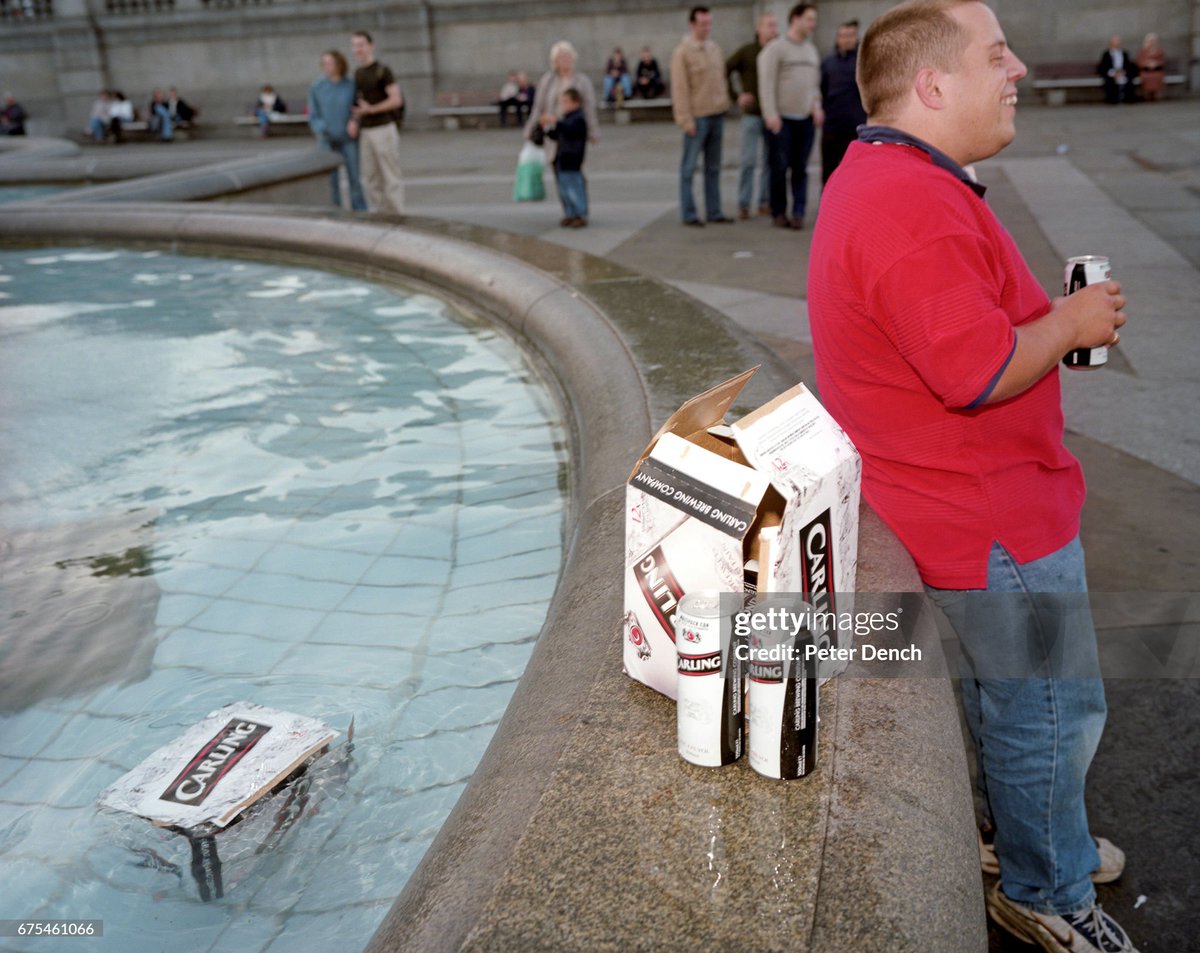 An England football fan attempts to keep his beer chilled in a fountain in London's Trafalgar Square (2001)