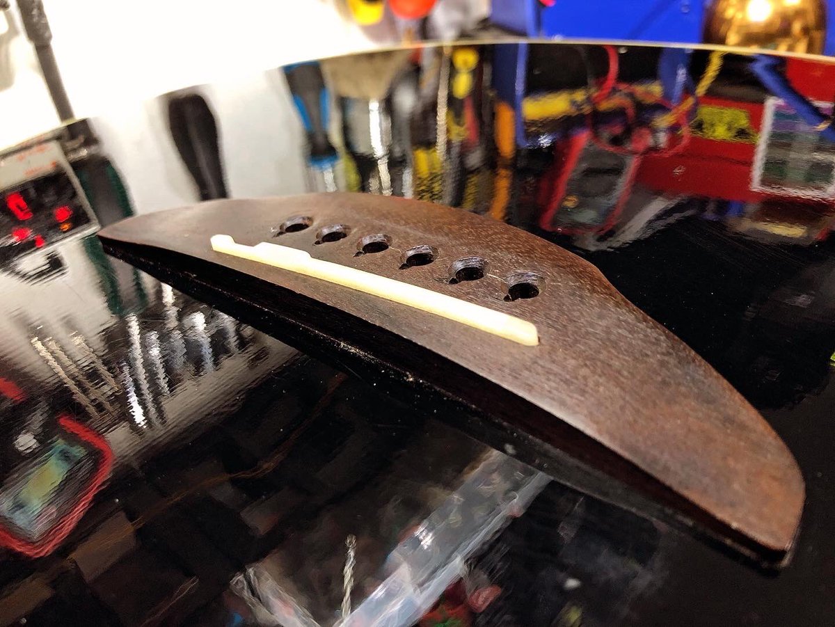 Fitting a ceramic #guitar bridge using a machined blank. We want a nice low action here with good tone transfer. This #acousticguitar came in with very high strings. Much better now. On it’s way home soon. Thanks for following along 🎸