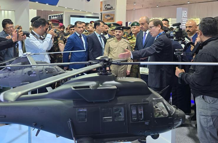 Korea Aerospace Industries (KAI) CEO Kang Goo-young, third from right, shows a KUH-1 Surion helicopter to Iraqi Defense Minister Thabet Muhammad Al-Abasi and other Iraqi defense officials at the firm's booth at the 2024 International Defense Exhibition in Iraq (IQDEX) in Baghdad.