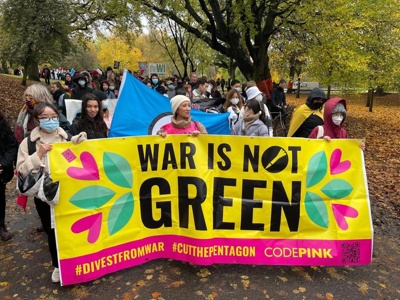 This photo shows @codepink campaigners marching in Glasgow during #COP26 in  November 2021 #WarIsNotGreen