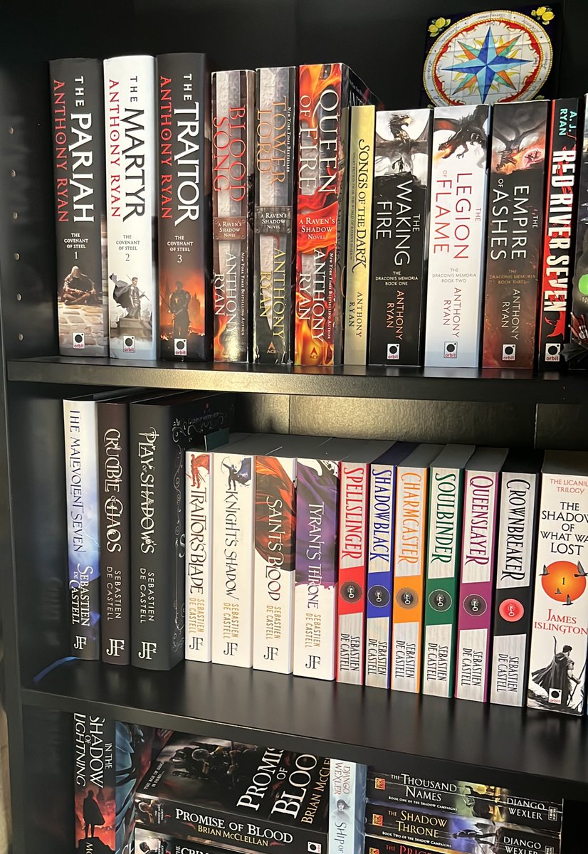 @writer_anthony and @decastell going toe to toe on shelf space it seems. This pleases me for some reason. Even though technically I have the Raven’s Blade duology in digital because I can’t get the US paperbacks yet and I like my series editions to match🤣