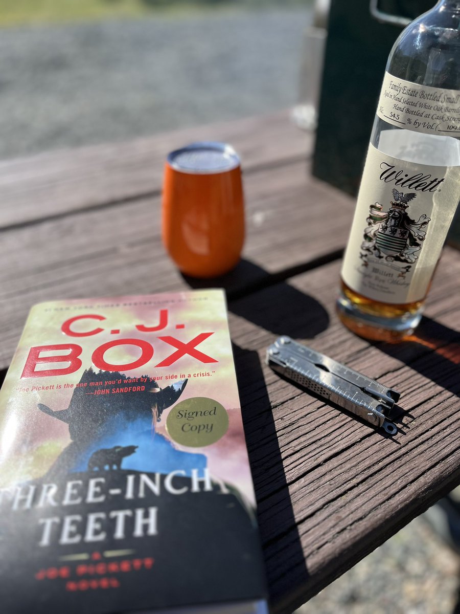 loepermann's tweet photo. Maybe not the right book to be reading while sleeping in a tent in the Tobacco Roots. @cjboxauthor #ThreeInchTeeth https://t.co/JUwIJsMP0d