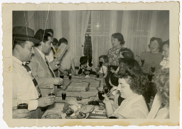 Happy Passover from the Center for Brooklyn History! 🔯 . . A Syrian Jewish family gathered for Passover Seder reading the Haggadah at the dinner table, 1952, BJHP_0013; Brooklyn Jewish History Project, Brooklyn Public Library, Center for Brooklyn History.