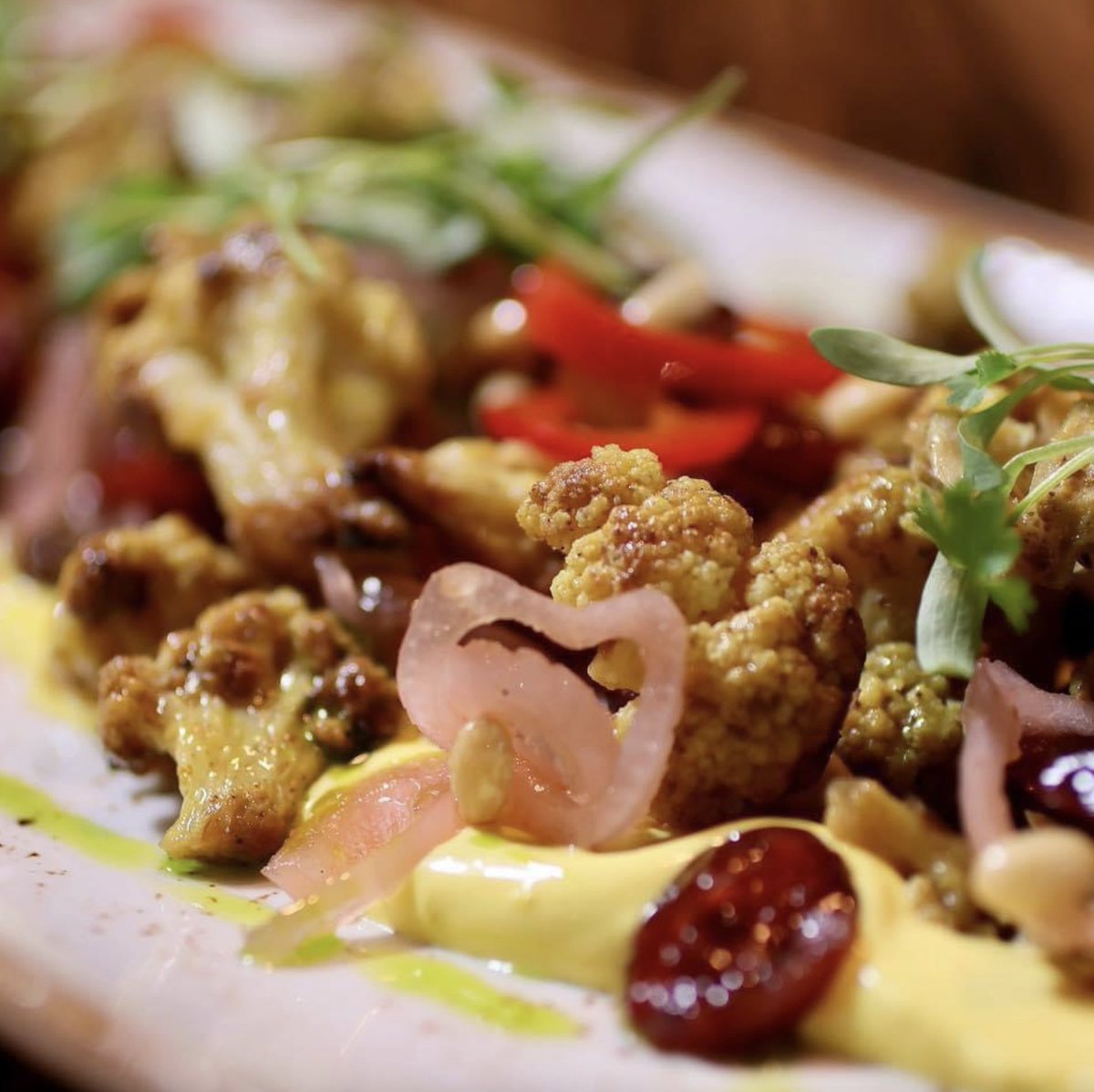 An up close & personal shot of our curried cauliflower happy hour dish to make sure you see all of the levels of flavor when you take just one bite 🤤 Join us for our all day/night HH after work today for a sweet ending to your Monday! #coppershark #happyhour #baltimoreeats